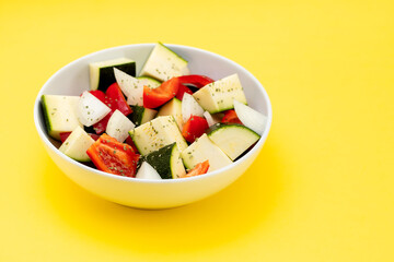 fresh vegetables in cubes in the white bowl