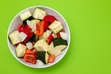 fresh vegetables in cubes in the white bowl