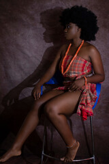 Beautiful Young African Nigerian Woman in Native Traditional Attire with Afro Hair and beads Semi Nude Boudoir