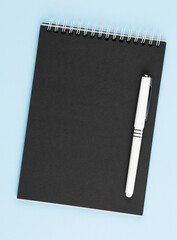 open black notebook on blue table