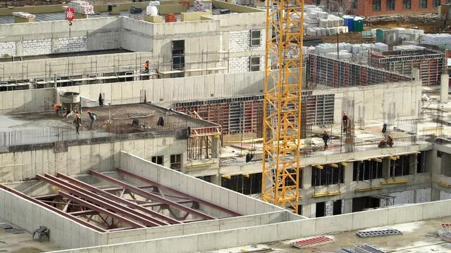 Time lapse of workers at large construction site pour and level concrete, work with steel concrete reinforcement. Advanced building technology and modern monolithic construction. Сonstruction industry