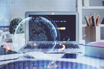 Double exposure of desktop with computer and world map hologram. International data network concept.