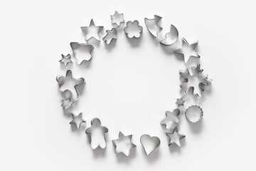Banner of Christmas-themed cookie cutters on white. Holiday card. Top view and flat lay. Xmas pattern.
