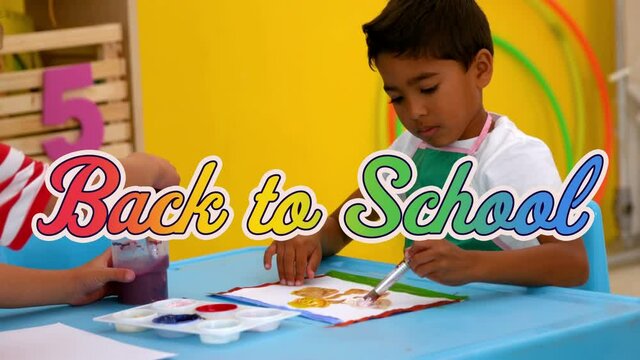 Digital animation of back to school multicolored text against two boys wearing apron painting in cla