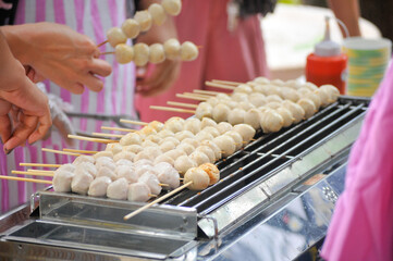 Grilled meatballs skewer bamboo with coriander topping ,