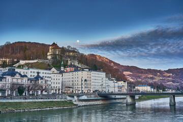 Fototapeta premium Artadecer en Salzburgo con la salida de la luna y el rio con su puente