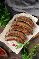 Fried sausages. Grilled sausages with spices on a wooden serving Board. Delicious meat sausages