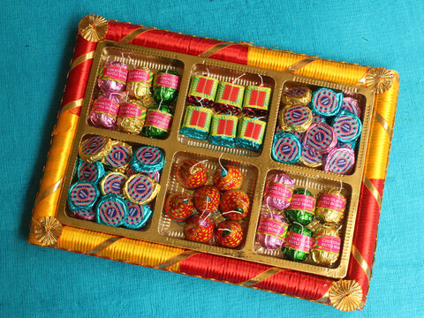 Diwali celebrations with fire crackers shaped homemade chocolates inside a gift box