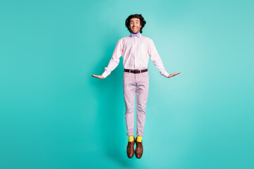 Fototapeta na wymiar Full size photo of flirty jumping young guy dressed formal outfit yellow socks isolated on turquoise color background