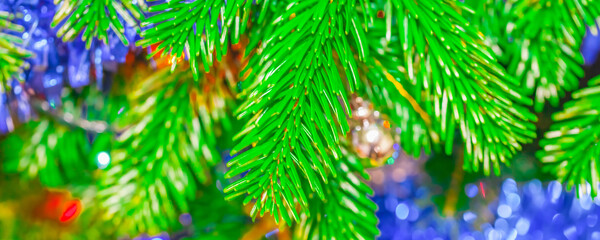 Fototapeta na wymiar Bright christmas tree with decorations and colorful lights, soft focus blurry background