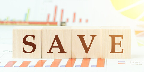 word safe with letters on wooden cubes on desk with graphs