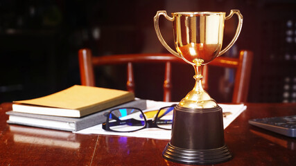 Trophy on working table, win concept...