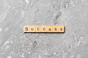 Success word written on wood block. Success text on table, concept