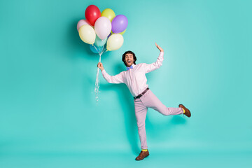 Fototapeta na wymiar Full body portrait of amazed funky man show fly dressed formalwear hold balloons isolated on turquoise color background