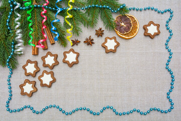 Decorative Christmas background with spruce branches, serpentine, gingerbread and decorations