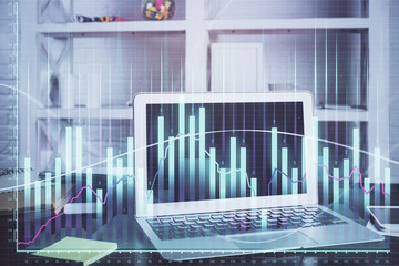 Stock market graph and table with computer background. Multi exposure. Concept of financial analysis.