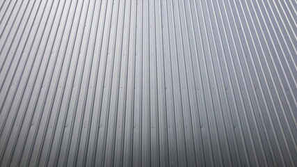 Gray metal sheet fence wall. Vertical corrugated sheet surface for a backdrop background. Selective focus
