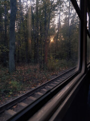Fototapeta premium Railway and window, sunlight and sunshine, trees and autumn atmosphere 