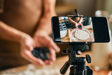 Male blogger filming video content about cooking pie