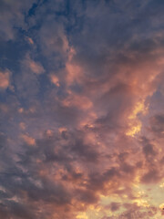 Obraz premium Orange and pink and blue sky and clouds, beautiful colours of the evening sunset sky 
