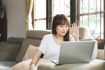 Naklejka premium Asian teenager woman learning via internet video conference with laptop.