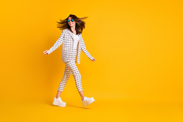 Full length body size side profile photo of girl wearing round sunglass hurrying up isolated on vibrant color background with blank space