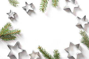 Christmas-themed cookie cutters stars on white. Holiday Xmas greeting card. Top view.