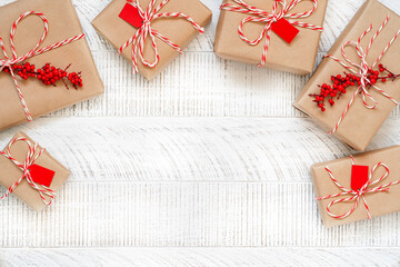 Christmas presents on the white wooden background with copy space. Top view of gift boxes decorated...