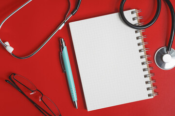 Stethoscope on a red table, concept medicine