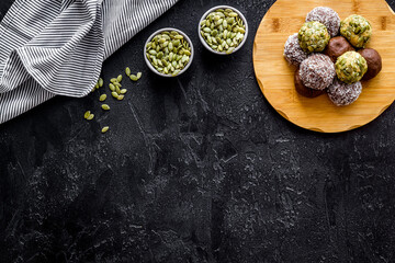 Obraz na płótnie Canvas Homemade raw chocolate balls - vegan truffles with cacao and coconut