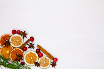 Fototapeta na wymiar Christmas food on a white background. Ingredients for cooking - cranberries, rosemary, orange and anise on a white background. Top view copy space.