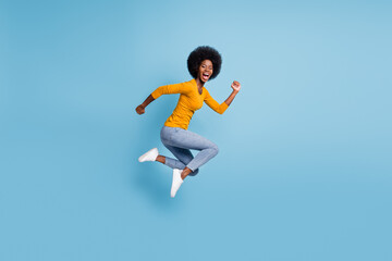 Fototapeta na wymiar Photo portrait full size of woman running jumping up isolated on pastel blue colored background