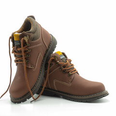 Winter men's youth boots with laces. Brown leather, metal hardware, thick grooved sole. Sewn with white lines. Isolated over white background.