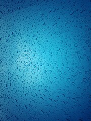Close up texture water droplets raindrop on beautiful blue metallic background image for abstract background.