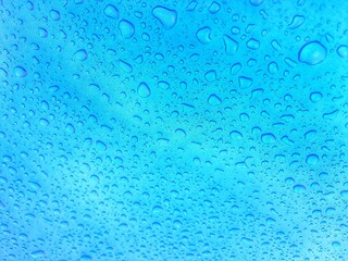 Close up texture water droplets raindrop on beautiful blue metallic background image for abstract background.
