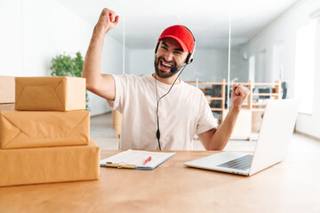 Happy call center worker at parcel distribution center