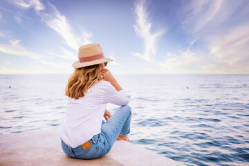 Full length shot of woman daydreaming while relaxing by the sea