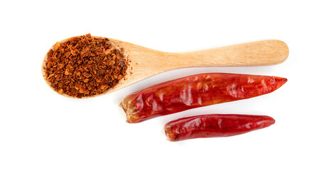 red ground paprika powdered or dry chili pepper with wooden spoon isolated on white background