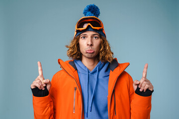 Close up of an upset young man wearing winter jacket