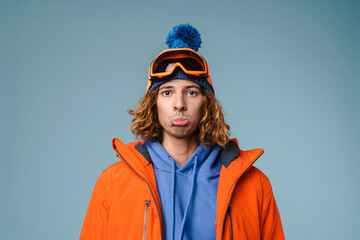 Close up of an upset young man wearing winter jacket