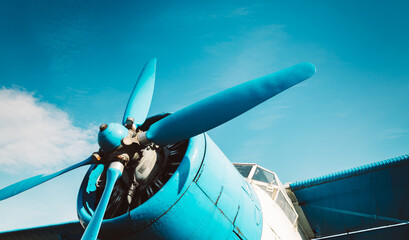Engine and propeller of an airplane close up. Front of a propeller driven airplane. Single propeller. Retro style.