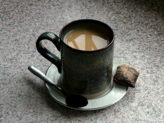 Mug of tea with teaspoon and teabag