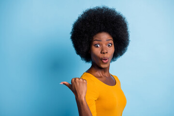 Photo portrait of surprised amazed black skinned girl pointing with finger at empty space isolated...