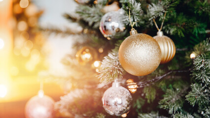 Banner Christmas tree with decorations and illumination, sun glare bokeh in background