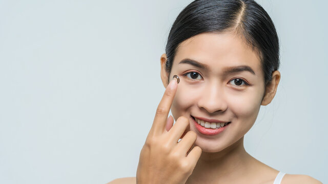 Close-up Young Asian Woman Wearing Contact Lens, Macro Shot.