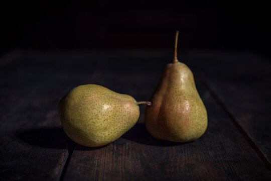 Two pears on the wooden table - vintage style photography