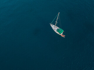 Aerial view of boats moored in the Atlantic Ocean at the jagged shores and beaches of Lanzarote, Spain, Canary Islands
