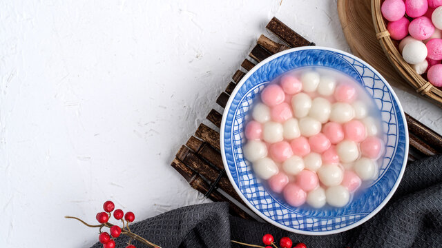 Top view of red and white tangyuan in blue bowl on white background for Winter solstice. - Powered by Adobe