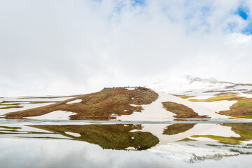 scenic view of the frozen lake Kari high in the mountains of Armenia in summer