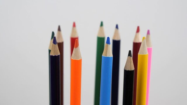 A collection of colored pencils rotating in a circle